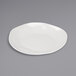 A Cal-Mil ivory melamine plate on a gray surface.