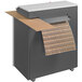 A HSM cardboard shredder with brown paper in it.