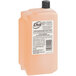 A bottle of Dial hair and body wash refill with orange liquid soap.
