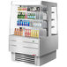 A stainless steel Turbo Air self-serve island display cooler with drinks on shelves.