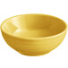 A yellow Acopa Capri stoneware bowl with a handle.