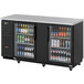 A Turbo Air Super Deluxe back bar cooler with glass doors filled with beer bottles.