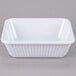 A white rectangular melamine casserole dish with a ribbed edge.