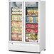 A Turbo Air white swing door freezer with glass doors filled with a variety of food items.