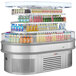 A Turbo Air stainless steel open air oval display case full of drinks.
