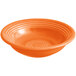 An orange Acopa stoneware bowl with a swirl design.