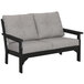 A black POLYWOOD loveseat with grey cushions.