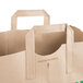 A Duro brown paper shopping bag with green handles.