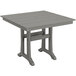 A POLYWOOD square grey dining table with trestle legs and a wooden top.