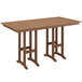 A brown POLYWOOD bar height table on an outdoor patio.