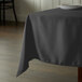 A table with a black Intedge tablecloth on it.