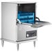 A Noble Warewashing undercounter dishwasher with a blue crate inside.