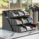 A black Choice self-serve organizer set with condiments on a counter.