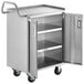 A Regency stainless steel utility cart with open doors.