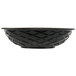A black round weave polyethylene basket on a table.