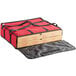 A red Choice insulated pizza bag holding a pizza box.