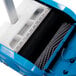 A blue and white Namco Floorwash 5000 walk behind floor scrubber with a grey brush inside.