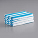 A stack of Monarch Brands blue and white striped pool towels.