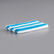 A pack of 4 blue and white striped Monarch Brands pool towels.