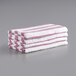 A stack of lavender and white striped Monarch Brands pool towels.