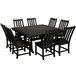 A POLYWOOD black dining table with a square top and chairs around it on an outdoor patio.