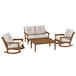 A group of POLYWOOD outdoor furniture with a coffee table, a white rocking chair, and two white chairs.