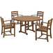 A POLYWOOD teak patio table with a round top and four arm chairs.