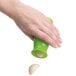 A person using an OXO Good Grips green garlic peeler.