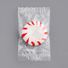 A plastic bag filled with red and white Peppermint Starlite Mints.