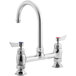A silver Waterloo deck-mount faucet with two handles and a gooseneck spout. The handles are red and blue.