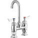 A silver Waterloo deck mount faucet with red handles.
