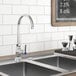 A Waterloo deck-mount faucet with a gooseneck spout over a sink with a chalkboard above it.