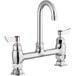 A silver Waterloo deck mount faucet with chrome gooseneck spout and red knobs.