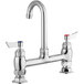 A chrome Waterloo deck-mount faucet with two silver handles with red and blue accents.