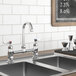 A Waterloo deck-mount faucet with gooseneck spout and sink over a metal counter.