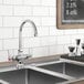 A Waterloo deck-mount faucet with a gooseneck spout on a kitchen counter above a sink.