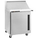 A silver Traulsen refrigerated sandwich prep table with a white lid.