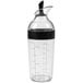 An OXO clear plastic salad dressing shaker with a black lid.