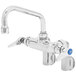 A T&S chrome wall mount pantry faucet with blue handles.