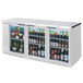 A Beverage-Air stainless steel back bar refrigerator with glass doors filled with bottles of beer.
