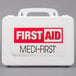 A white Medique first aid kit with a red and black label and a handle.