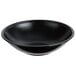 A black Cambro salad bowl with a black rim on a white background.