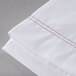 A white Oxford Superblend Microfiber Twin Size flat sheet with red stitching.