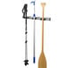 A Toolflex garage storage organizer with a paddle, a wooden stick with a red top, and a pole holder.