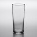 An Arcoroc Essentials Collins glass with a black rim on a white surface.