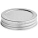 A close-up of a silver metal Arcoroc mini mason jar lid.