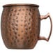 An Arcoroc copper mug with a hammered antique finish and a handle.