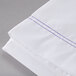 A white Oxford T180 full size flat sheet with blue stitching.