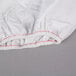A white Oxford T180 Superblend fitted sheet with red stitching.