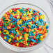 A bowl filled with colorful alphabet sprinkles.